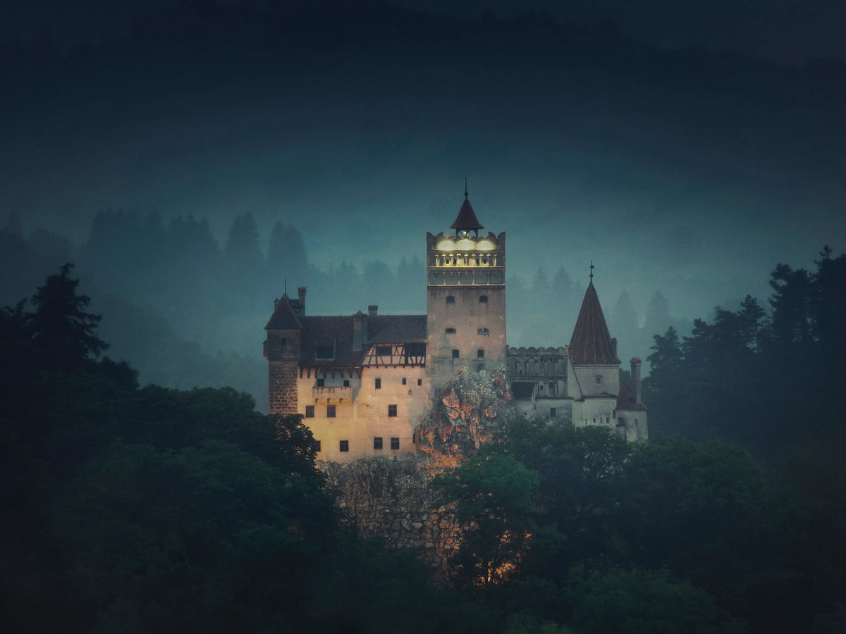 Bran Castle rising above its wooded rock